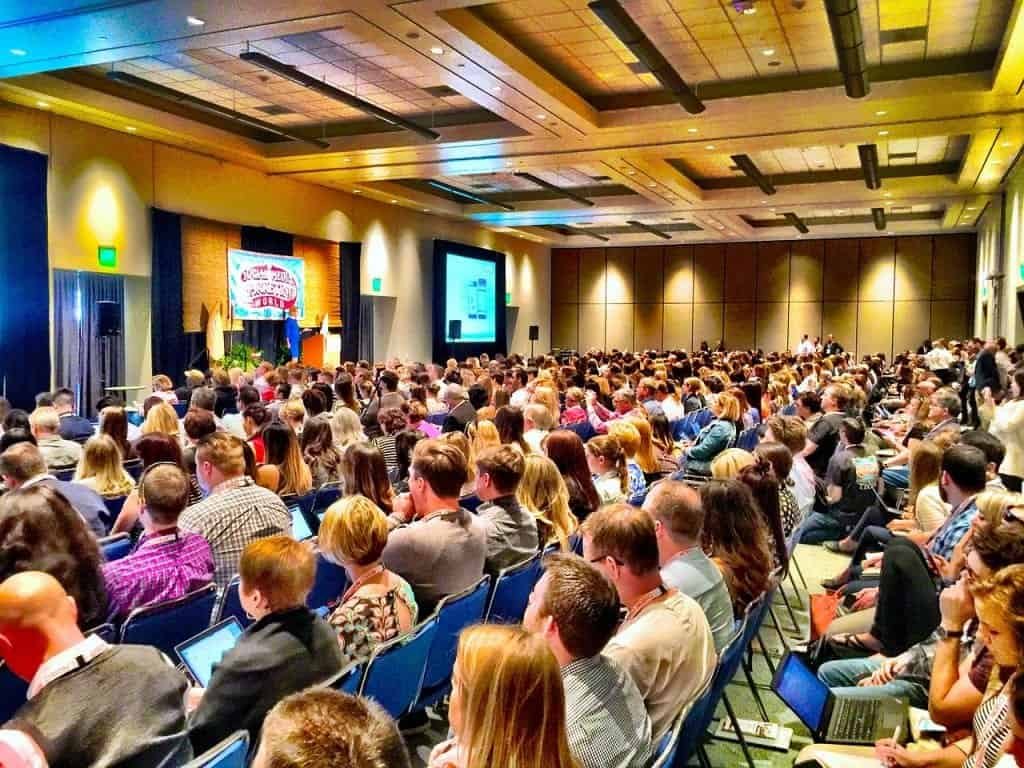 A packed hall of students at a union meeting, many with laptops open